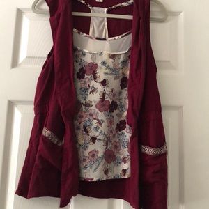 A floral tank top and a sleeveless hooded jacket.